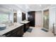 This main bathroom features double sinks, white countertops, and a glass-enclosed shower at 3045 Moss Stone Lane Sw Ln, Marietta, GA 30064