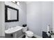 Elegant powder room with a pedestal sink, decorative mirror, and modern fixtures at 3045 Moss Stone Lane Sw Ln, Marietta, GA 30064