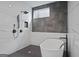 Luxurious bathroom with a sleek soaking tub, marble-look shower, and black hardware at 569 Middle Sw St, Atlanta, GA 30310