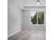 Bright bedroom featuring a ceiling fan, gray walls, and hardwood flooring with a large window overlooking trees at 569 Middle Sw St, Atlanta, GA 30310