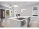 Stylish kitchen island featuring a sink and view of a fireplace, blending contemporary design with comfort at 569 Middle Sw St, Atlanta, GA 30310