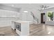 Modern kitchen with island, stainless steel microwave, and sleek white cabinetry, ideal for culinary enthusiasts at 569 Middle Sw St, Atlanta, GA 30310