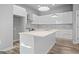Contemporary kitchen with island, stainless steel range hood, and elegant backsplash, blending style and functionality at 569 Middle Sw St, Atlanta, GA 30310