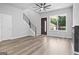 Inviting living room featuring a modern fireplace, sleek ceiling fan, and stylish staircase at 569 Middle Sw St, Atlanta, GA 30310