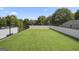 Spacious rooftop deck with a sleek railing and artificial turf, surrounded by lush greenery at 569 Middle Sw St, Atlanta, GA 30310