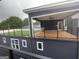 Modern rooftop patio featuring artificial grass, wood patio, and covered outdoor space with railing at 569 Middle Sw St, Atlanta, GA 30310