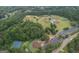 Aerial view showcasing multiple baseball fields and tennis courts surrounded by lush greenery at 10980 Pinehigh Dr, Alpharetta, GA 30022