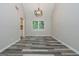 Dining room with modern light fixture, wood-look flooring, and large window at 10980 Pinehigh Dr, Alpharetta, GA 30022