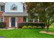 Charming home exterior showcasing manicured landscaping, a brick facade, and an inviting front entrance at 10980 Pinehigh Dr, Alpharetta, GA 30022