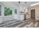 Sunlit kitchen with stainless steel appliances, granite counters and wood-look flooring at 10980 Pinehigh Dr, Alpharetta, GA 30022
