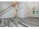 Bright living room featuring wood-look flooring, vaulted ceiling, and staircase at 10980 Pinehigh Dr, Alpharetta, GA 30022