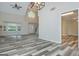Bright living room with hardwood floors, large windows, high ceiling, and modern light fixture at 10980 Pinehigh Dr, Alpharetta, GA 30022