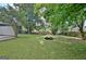 Beautifully landscaped backyard with mature trees and a fire pit, perfect for outdoor gatherings at 110 Chesterfield Ct, Fayetteville, GA 30214