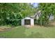 Backyard with a storage shed surrounded by mature trees, perfect for outdoor storage and activities at 110 Chesterfield Ct, Fayetteville, GA 30214