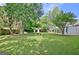 Landscaped backyard with mature trees, a storage shed, and a fire pit area at 110 Chesterfield Ct, Fayetteville, GA 30214