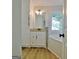 Bathroom with vanity, tub and wood look floors, offering a relaxing retreat at 110 Chesterfield Ct, Fayetteville, GA 30214