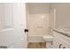 Bathroom view of tub/shower, toilet and granite-topped vanity at 110 Chesterfield Ct, Fayetteville, GA 30214