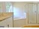 Bright bathroom boasts a soaking tub with a separate glass shower at 110 Chesterfield Ct, Fayetteville, GA 30214
