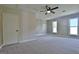 Spacious bedroom features wood paneling, plush carpet, and ample natural light from the windows at 110 Chesterfield Ct, Fayetteville, GA 30214