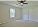 Bedroom with carpet, ceiling fan and window with view of trees at 110 Chesterfield Ct, Fayetteville, GA 30214
