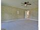 Large bedroom featuring plush carpet, wood paneling accent wall, and neutral colors at 110 Chesterfield Ct, Fayetteville, GA 30214