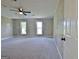 Bedroom with wall panels, fan, carpet floors, and two windows at 110 Chesterfield Ct, Fayetteville, GA 30214