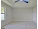 Bright bedroom featuring plush carpet, neutral colored walls, and tray ceiling at 110 Chesterfield Ct, Fayetteville, GA 30214