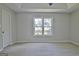 Bright bedroom with large window, plush carpet and neutral colored walls at 110 Chesterfield Ct, Fayetteville, GA 30214