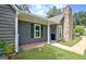 View of the home's entrance featuring a covered front porch with white columns and neatly kept landscaping at 110 Chesterfield Ct, Fayetteville, GA 30214