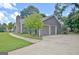 Features a two-car garage with a concrete driveway and well-maintained lawn at 110 Chesterfield Ct, Fayetteville, GA 30214