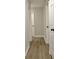 Hallway with wood flooring and multiple doors, offering access to various rooms at 110 Chesterfield Ct, Fayetteville, GA 30214