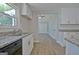 Bright kitchen boasts granite counters, white cabinets, stainless steel sink, and modern appliances at 110 Chesterfield Ct, Fayetteville, GA 30214