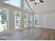 Bright living room featuring vaulted ceiling, many windows, fan, and vinyl floors at 110 Chesterfield Ct, Fayetteville, GA 30214