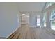 Open-concept living room features vaulted ceiling, vinyl floors, many windows, and view into the kitchen at 110 Chesterfield Ct, Fayetteville, GA 30214