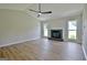 Inviting living room featuring a fireplace, ceiling fan, and natural light at 110 Chesterfield Ct, Fayetteville, GA 30214