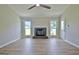 Cozy living room featuring a fireplace, windows, and wood-look flooring at 110 Chesterfield Ct, Fayetteville, GA 30214