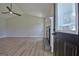 Bright open-concept living room featuring wood-look flooring, a fireplace and ceiling fan at 110 Chesterfield Ct, Fayetteville, GA 30214