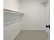 Empty walk-in closet with rod and shelf, offering plenty of storage at 110 Chesterfield Ct, Fayetteville, GA 30214