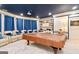 Entertainment basement with pool table, cozy seating, and a projector setup for movie nights at 2230 Cambridge Hill Ct, Dacula, GA 30019