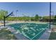 Outdoor basketball court featuring green surface, lighting and nets in a recreation area at 2230 Cambridge Hill Ct, Dacula, GA 30019