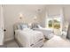Comfortable bedroom with twin beds, soft blue accents, and plenty of natural light from the window at 2230 Cambridge Hill Ct, Dacula, GA 30019