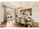 Formal dining room with hardwood floors, picture window, and modern chandelier at 2230 Cambridge Hill Ct, Dacula, GA 30019