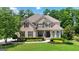 Stunning brick and stone home featuring manicured landscaping and a lush green lawn at 2230 Cambridge Hill Ct, Dacula, GA 30019
