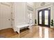 Elegant foyer boasts hardwood floors, decorative molding, and a stylish bench at 2230 Cambridge Hill Ct, Dacula, GA 30019