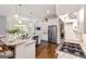 Spacious kitchen featuring stainless steel appliances, island, and modern lighting at 2230 Cambridge Hill Ct, Dacula, GA 30019
