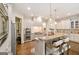 Modern kitchen featuring stainless appliances, double oven, island, and hardwood floors at 2230 Cambridge Hill Ct, Dacula, GA 30019