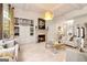 Bright living room with built-in shelving, fireplace, gold chandelier, and tile flooring at 2230 Cambridge Hill Ct, Dacula, GA 30019