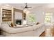 Cozy living room with stone fireplace, built-in shelves, and comfortable sectional sofa at 2230 Cambridge Hill Ct, Dacula, GA 30019