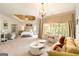 Bright bedroom with sitting area, a trey ceiling, lots of natural light and neutral colors at 2230 Cambridge Hill Ct, Dacula, GA 30019