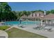 Large community pool with lounge chairs and tables surrounding it at 2230 Cambridge Hill Ct, Dacula, GA 30019
